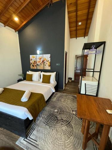 a bedroom with a bed and a desk in it at Ella moon rock in Ella