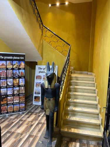 uma estátua em frente a uma escadaria numa loja em Pyramids Plateau View no Cairo