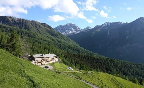 a house on a hill with mountains in the background at Civico 5 in Marmora