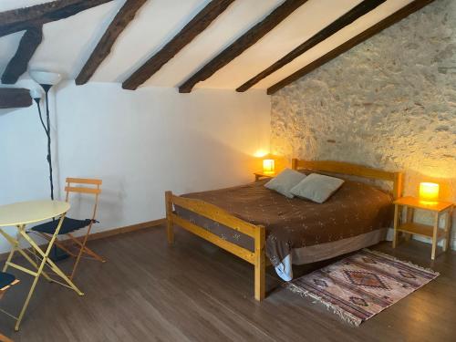 a bedroom with a bed and a table and a desk at CHEZ SOPHIE -Chambres d’hôtes, Gîte et Gîte équestre in Clermont-Dessous