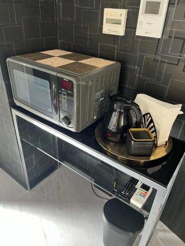 a microwave sitting on top of a shelf at 3minutes from the station Close to Asakusa, Tokyo Station and Narita Airport in Tokyo