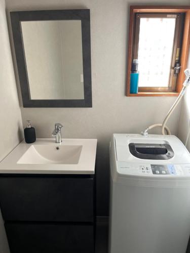 a bathroom with a sink and a washing machine at 3minutes from the station Close to Asakusa, Tokyo Station and Narita Airport in Tokyo