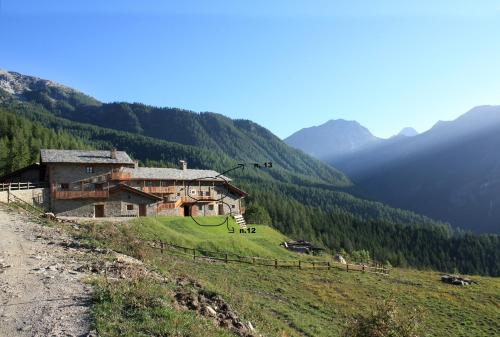a building on the side of a hill with mountains at Civico 5 in Marmora