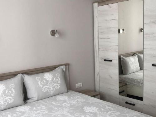 a bedroom with a bed and a large mirror at *HOT* Main Square Brand New Luxury Apartment in Burgas City