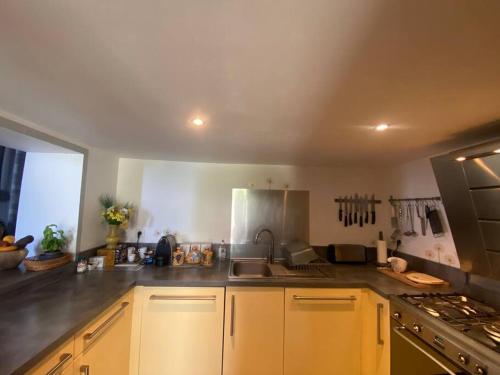 a kitchen with a sink and a stove top oven at Maison en bord de mer en Corse Lavasina Brando in Brando