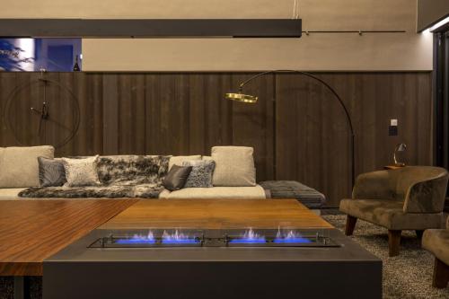 a living room with a couch and a table at Meikeikyo Hanazono in Kutchan