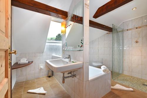 a bathroom with a sink and a toilet at Pension Pilsachhof in Arriach