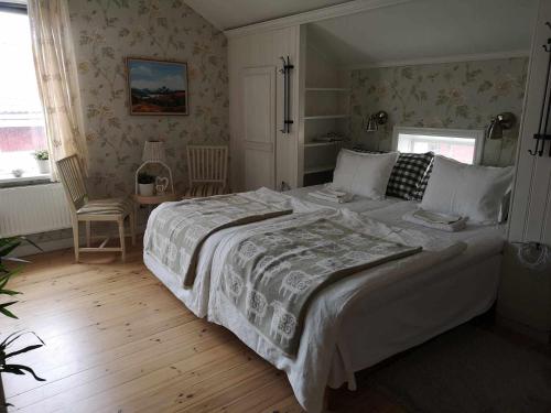 a bedroom with a large bed and a table and chairs at Kopparstugans Bed & Breakfast in Falun