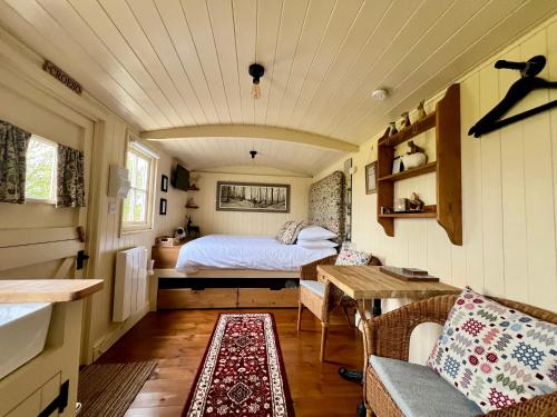 a bedroom with a bed in a tiny house at Shepherds Retreat Anglesey in Llanerchymedd
