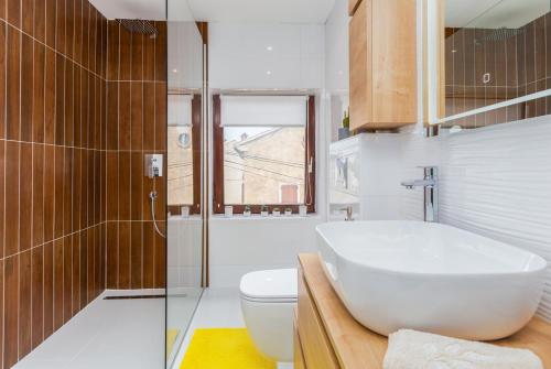 a bathroom with a white sink and a toilet at Evan Seaview in Funtana