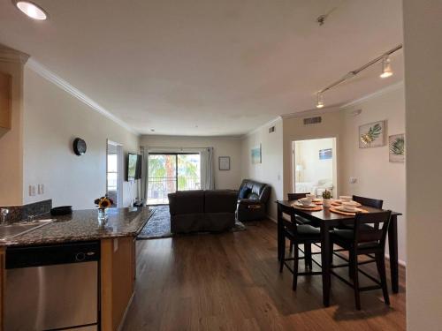 a kitchen and living room with a table and chairs at SoCal Lux on Bixel in Los Angeles