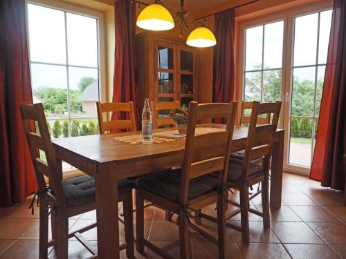 a dining room with a wooden table and chairs at Ferienhaus Mandy in Wohlenberg