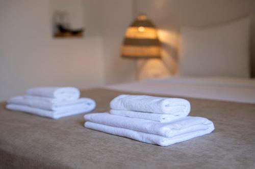three towels stacked on a counter in a bathroom at My Antalya in Antalya