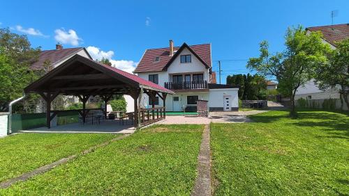 a house with a pavilion in the yard at Artemis Vendégház in Bogács