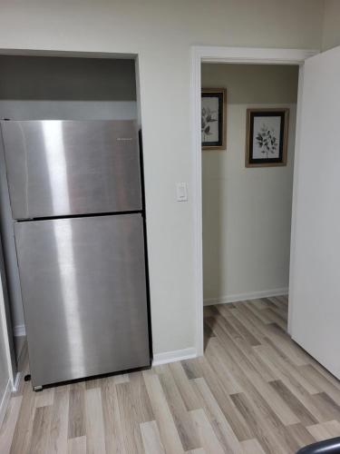 a kitchen with a stainless steel refrigerator in a room at Seeing Busch Gardens from two apartments in Tampa