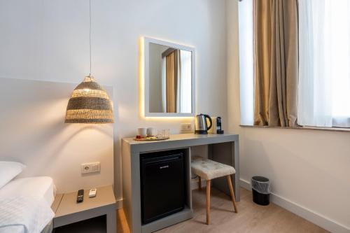 a bedroom with a desk and a mirror and a bed at My Antalya in Antalya