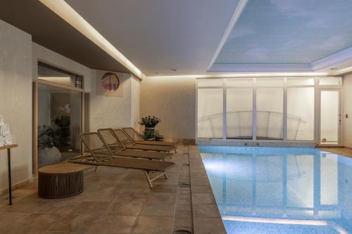 a swimming pool with lounge chairs and a swimming pool at Hotel Beach Palace in Blankenberge
