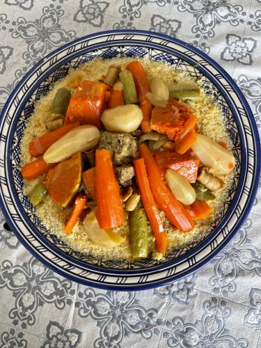 un tazón de zanahorias y otras verduras sobre una mesa en Gîte d’étape Chrifi en Anergui