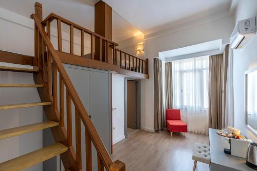 a staircase in a living room with a red chair at My Antalya in Antalya