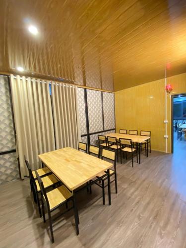 a row of tables and chairs in a room at Jewel Homestay in Hai Phong
