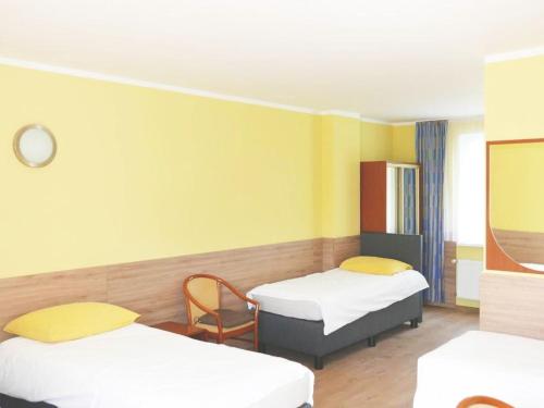 a hospital room with two beds and a chair at Reda in Mielno