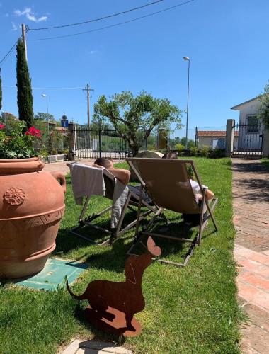 a person laying in lawn chairs and a cat statue at Palazzo Gessi Room and Breakfast in Borghi