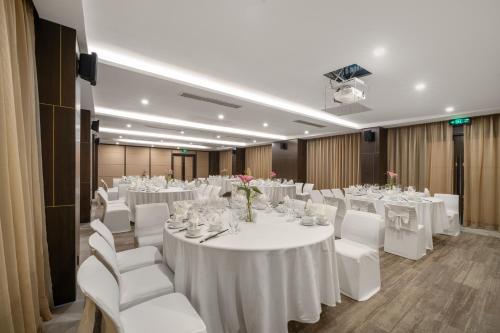 a conference room with white tables and white chairs at Satya Da Nang Hotel Han Market in Da Nang