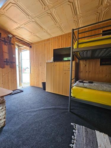 a room with two bunk beds and a tv at Na Mýtince in Moraň
