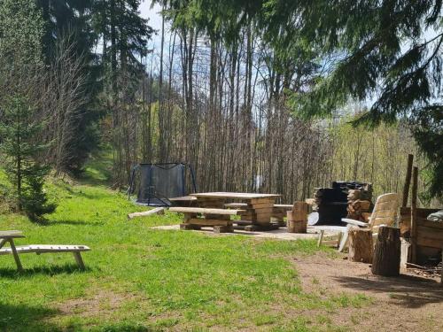 a group of picnic tables and a tent in a field at Penzion Pichberg Horská chata in Rokytnice nad Jizerou