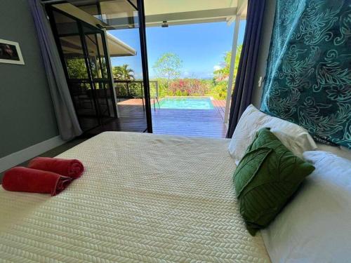 a bedroom with a large bed with a view of a pool at Macesuya Lodge in Zancudo