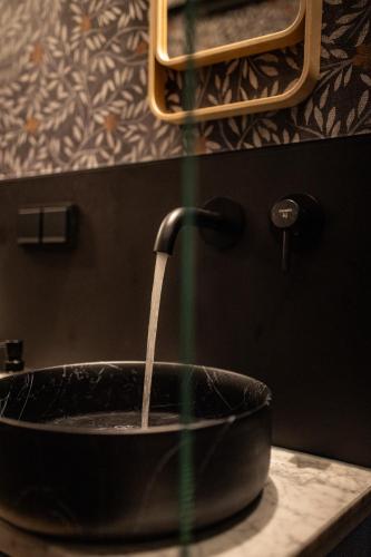 a sink with water coming out of it at Sadje in Rust