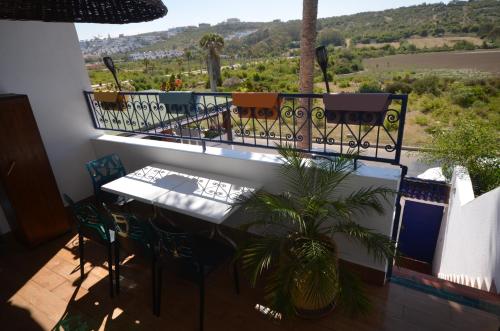 a balcony with a table and chairs and a view at Les appartements de la Villa Beida in Oualidia
