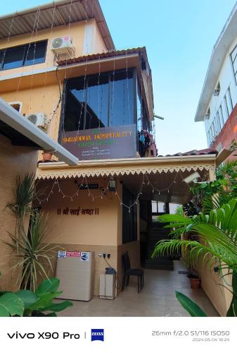 a building with a sign on the side of it at Shraddha hospitality in Calangute