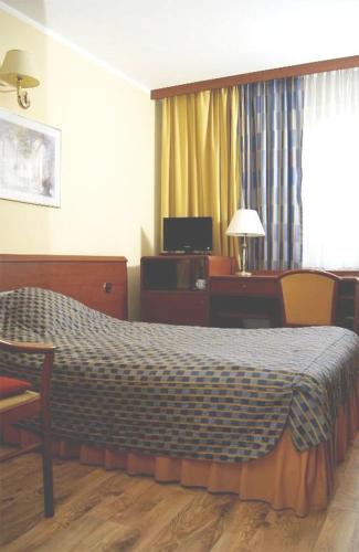 a hotel room with a bed and a desk at Reda in Mielno
