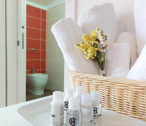 a bathroom with white towels and a basket of towels at Casa sulla Punta in Marina di Camerota