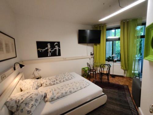 a bedroom with a bed and a flat screen tv at Have a nice home in Leipzig