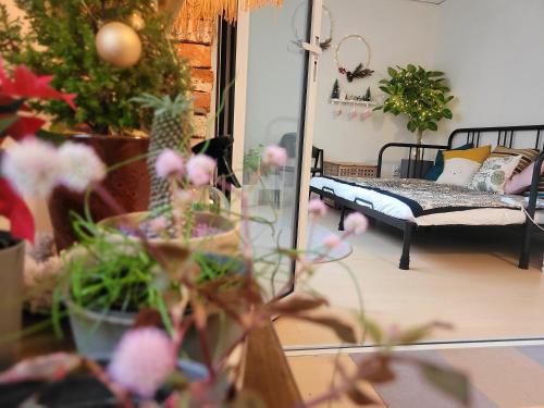 a living room with potted plants and a couch at Como Green House in Busan