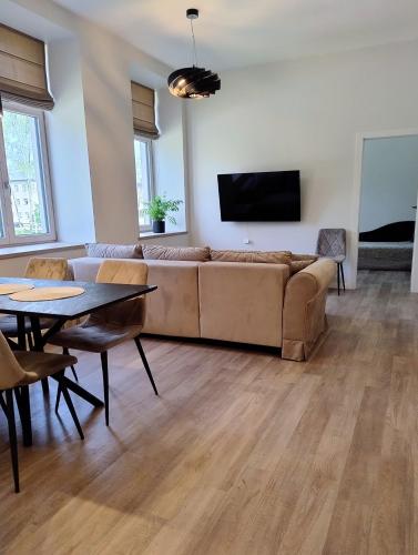 a living room with a couch and a table at Vytenio22- 2 bedrooms in Prienai