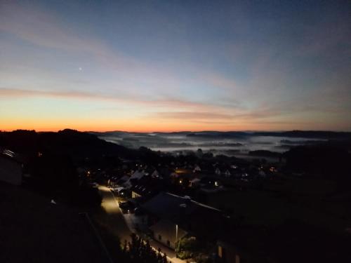 a view of a city at sunset with clouds at Ferienwohnungen Sternenhimmel WHG 1 in Medebach