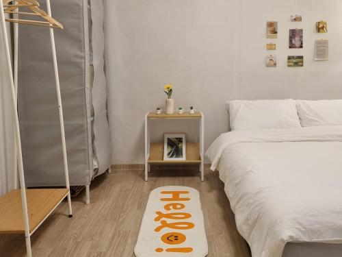 a room with two beds and a sign on the floor at Healing Stay in Seoul