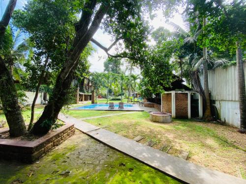 a house with a yard with a swimming pool at The Shade Brothers in Katunayake