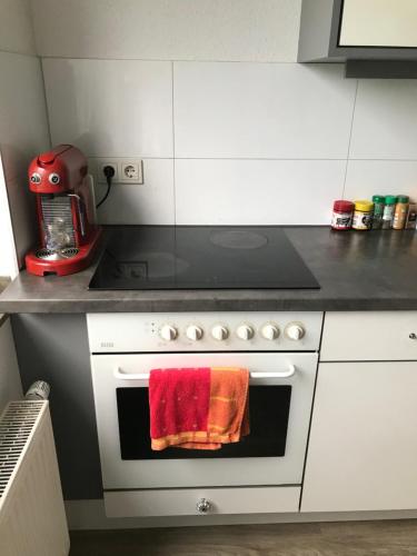 a kitchen with a stove with a red towel on the oven at FanHostel European Championship 24 Cologne City Center in Cologne
