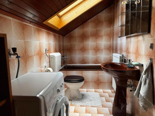 a bathroom with a tub and a toilet and a sink at Rooms Apartma Cerknica in Cerknica