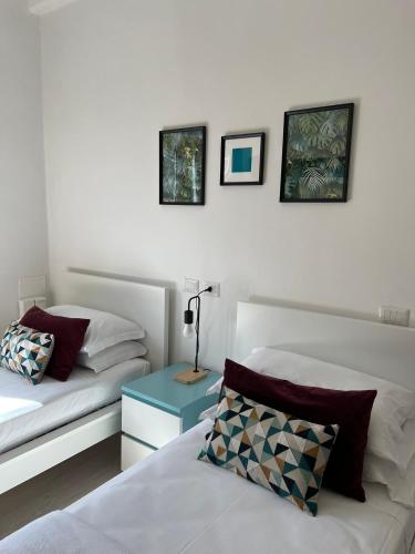 a bedroom with two beds and a table with a lamp at Charming Navona in Rome