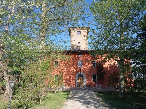 a brick building with a tower on top of it at Tenuta Torre Diana in Mordano