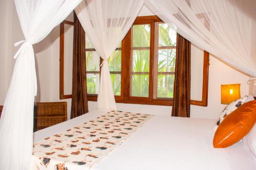 Giường trong phòng chung tại Beverly Africa Suites Malindi