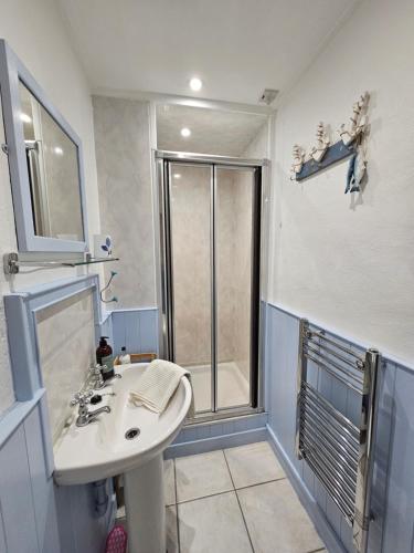 a bathroom with a sink and a shower at Crofters Retreat 