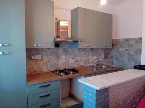 a kitchen with a sink and a counter top at Village SOGNO in Massa