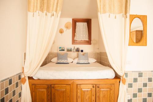 a bed in a bathroom with curtains and a mirror at Casa Danilo in San Teodoro