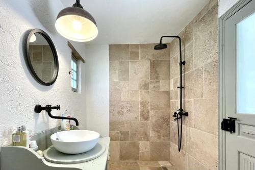 a bathroom with a sink and a shower at Casa din Port in Jurilovca